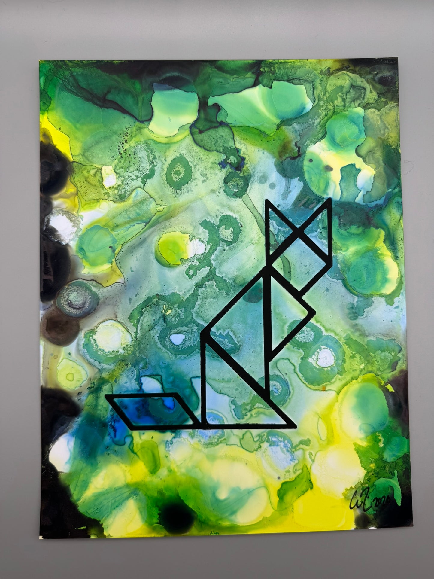 Abstract art piece with green and yellow colors and a black geometric design.