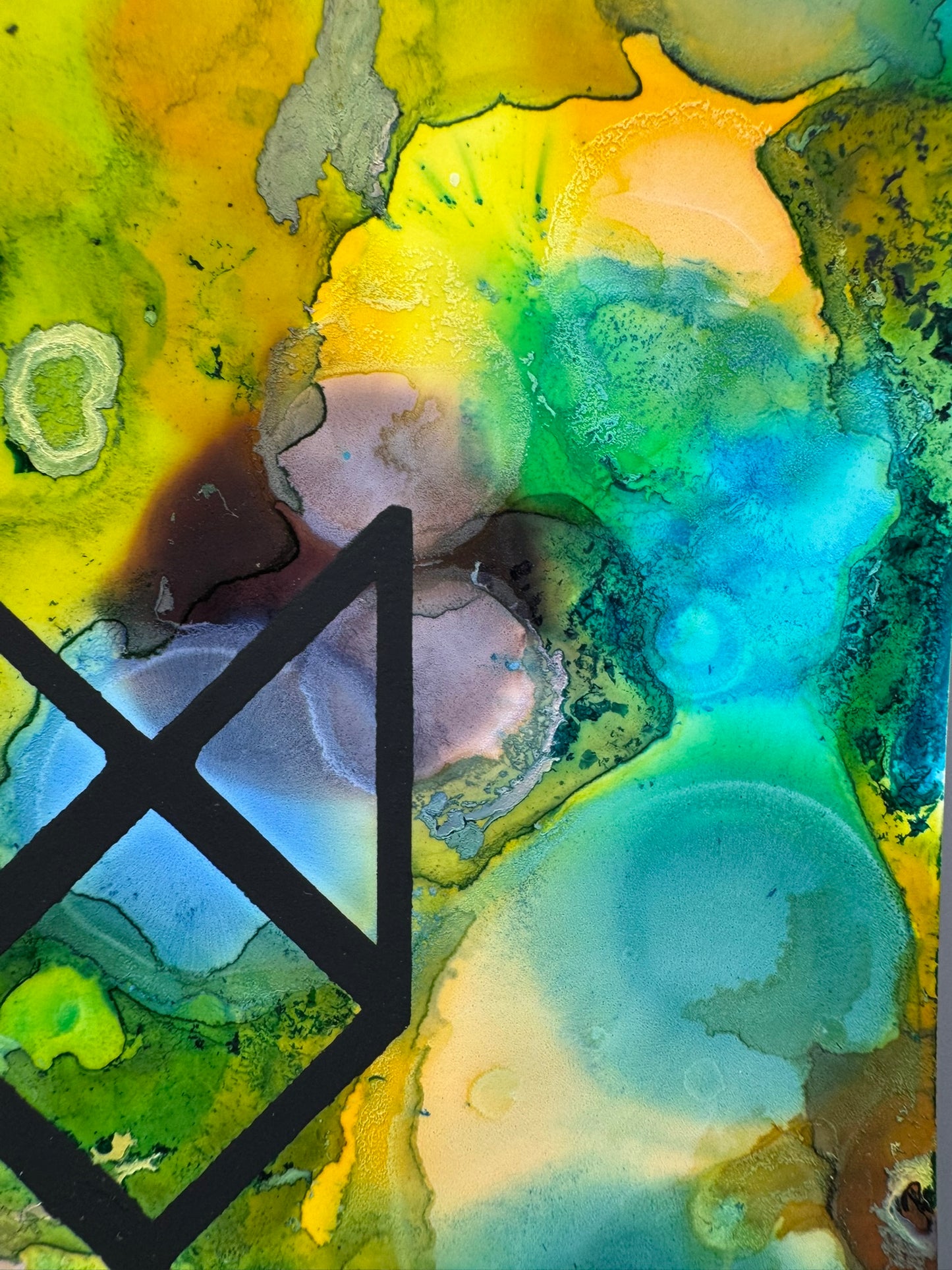 Abstract art with a black geometric shape on a multicolored background