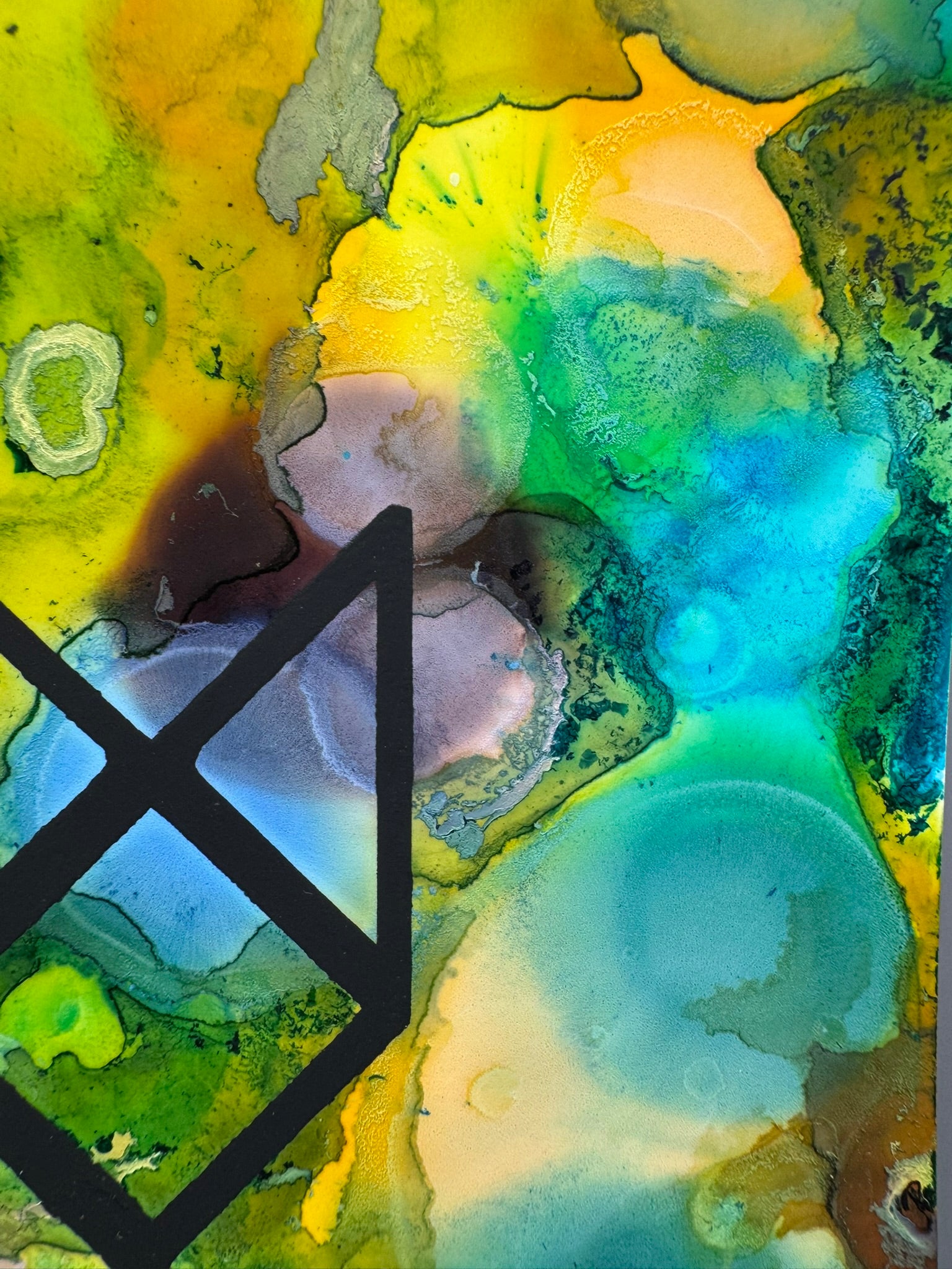 Abstract art with a black geometric shape on a multicolored background